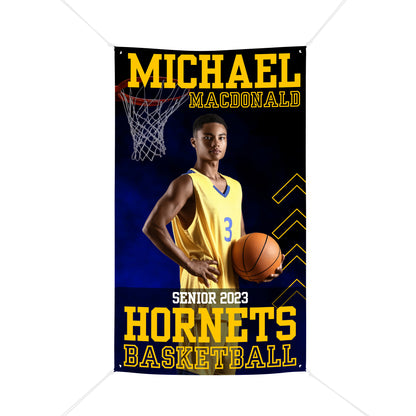 Blue and gold sports banner with a basketball player in a gold uniform holding a basketball. The banner is for his senior night as a high school varsity player.